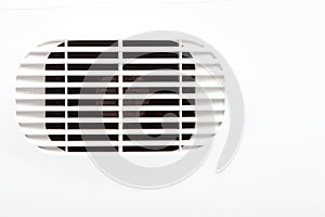 Plastic air vent in white wall ventilation grille