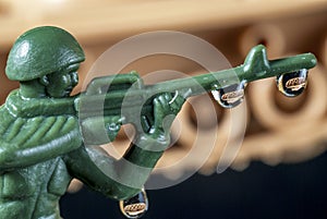 Plastic Army Man with drops and tank reflection