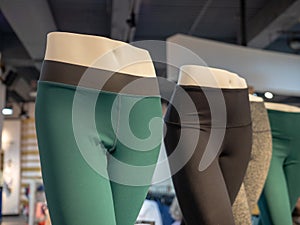 Plastic athletic mannequin lower bodies posing with yoga pants