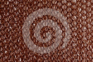 Plastic background texture cellophane wrapping packing wrap packet bead ball color maroon bordo brown chocolate