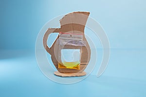 Plastic bag attached to cardboard cutout, pitcher craft concept