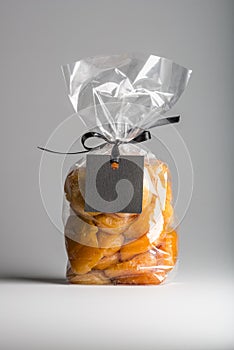 Plastic bag of dried apricots with black blank label