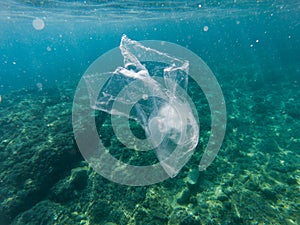 Plastic bag floating in the sea photo