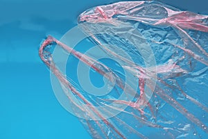 Plastic bag floating on water surface, top view. Ocean pollution