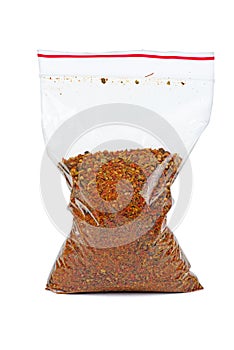 Plastic bag with mixed spices for barbecue isolated on white