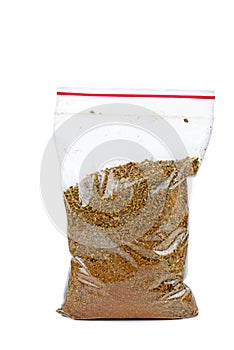 Plastic bag with mixed spices for barbecue isolated on white