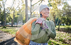 Plastic bag, park and woman cleaning in eco friendly, climate change or community service project for volunteering