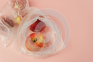 A plastic bag with a red apple inside