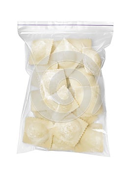 Plastic bag with uncooked ravioli on white background, top view