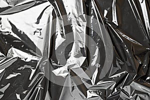 Plastic bag. Wrap transparent dark cellophane texture. Black shiny film pattern. Creative crumpled background