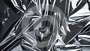 Plastic bag. Wrap transparent dark cellophane texture. Black shiny film pattern. Creative crumpled background