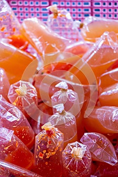 Plastic bags of chili sauce tied with rubber band