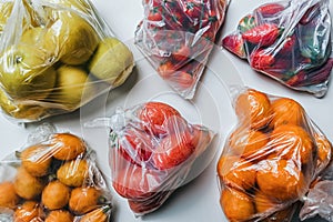 Plastic bags full of fruits and vegetables. Climate change concept