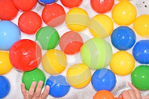 Plastic balls of different colors in bubble bath