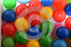 Plastic balls of different colors in bubble bath
