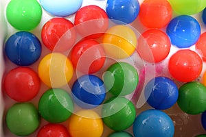 Plastic balls of different colors in bubble bath