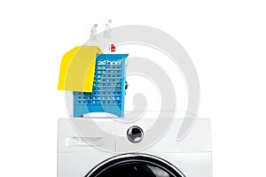 plastic basket with cleaning supplies on washing machine