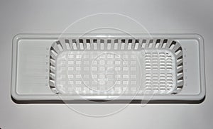 plastic basket for washing dishes on the sink. washing dishes. isolated white