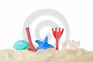 Plastic beach toys in sand