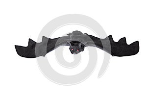 Plastic black bat with red vampire eyes, isolated on white. Halloween decoration.