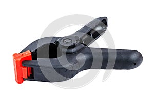 The plastic black clamp isolated on a white background