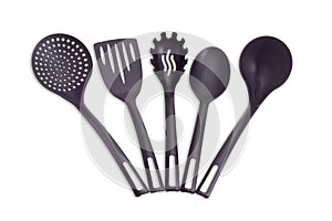 Plastic black cooking utensils on a light background