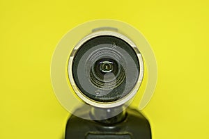 plastic black webcam lies on a yellow background