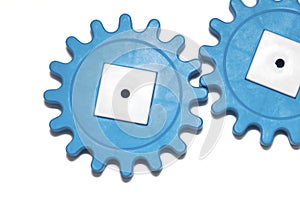 Plastic blue gears on a white background. The concept of interaction, process. The photo