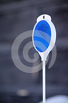 Plastic Blue Reflector Surrounded in White Plastic on Right Side of Photo