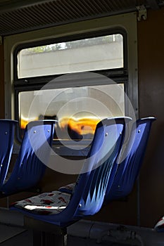 A plastic blue seat in a train car