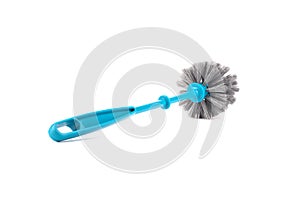 Plastic blue toilet brush with a handle to the camera