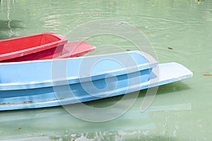 Plastic boat floating in the river.