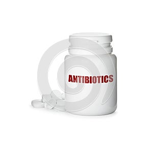 Plastic bottle with antibiotic pills on white background