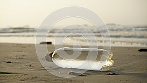 Plastic bottle is on the beach leave by tourist