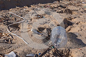 Plastic bottle on the beach, pollution photo