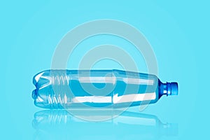 Plastic bottle on a blue background.Reflection. Products, packaging, storage, recycling