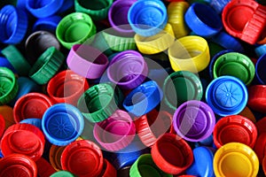 Plastic bottle caps background. Cap material is recyclable.Remove lids from plastic bottles before recycling them. Recycling