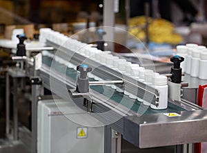 Plastic bottle on capsule filling machine conveyor belt