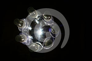 Plastic bottle containers in a circle of light photo