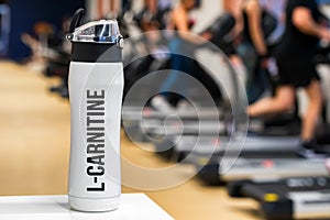 Plastic bottle or cup with L-Carnitine drink close up