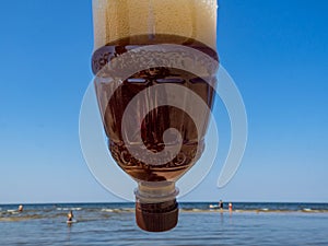 Plastic bottle of drink, beer or kvass, blue sky, global environment conservation concept