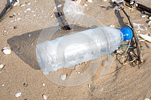 Plastic bottle or garbage on the sand beach.