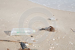 Plastic bottle or garbage on the sand beach.