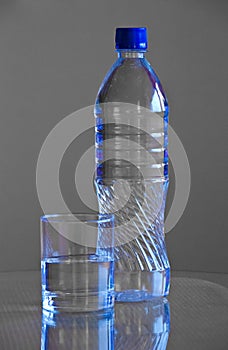 Plastic bottle and glass of water