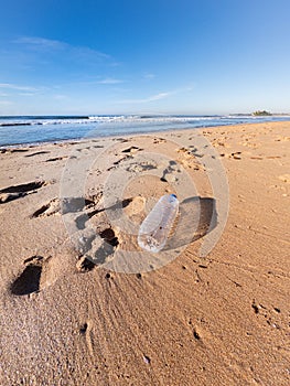 Plastic bottle left on the beach in Sri Lanka