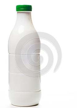 Plastic bottle of milk with a colored green cap isolated on white background