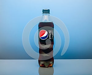 Plastic bottle of Pepsi Cola MAX 0.5 liters on a blue background. Zero calories Pepsi soft drink bottle isolated on blue