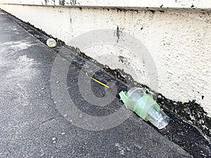 The plastic bottle or plastic glass discard on street