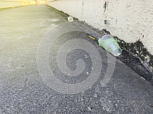 The plastic bottle or plastic glass discard on street