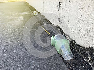 The plastic bottle or plastic glass discard on street